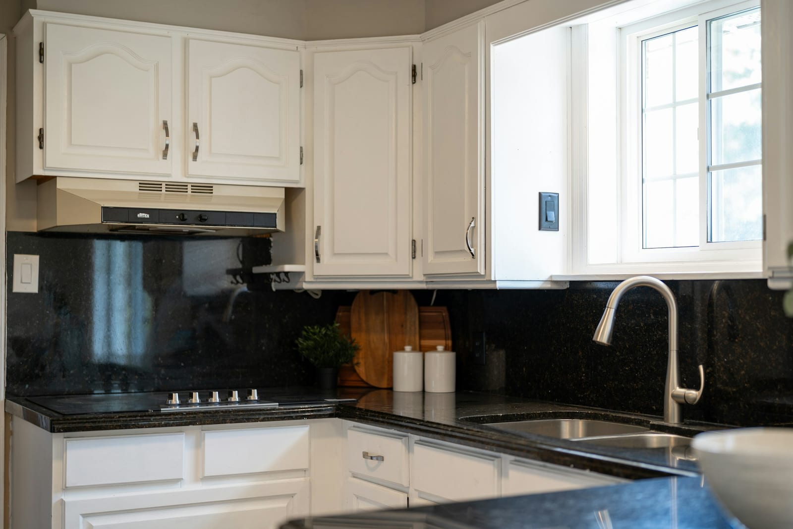 Refinished white kitchen cabinets in a Garland, TX home.