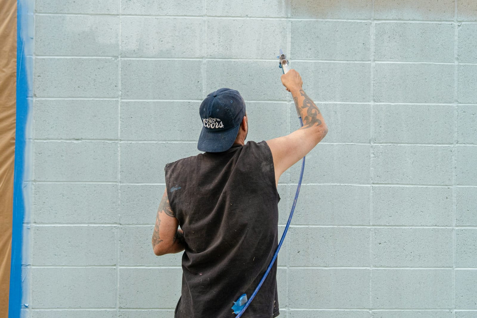 A professional painter finishing a wall in a Garland, TX home.