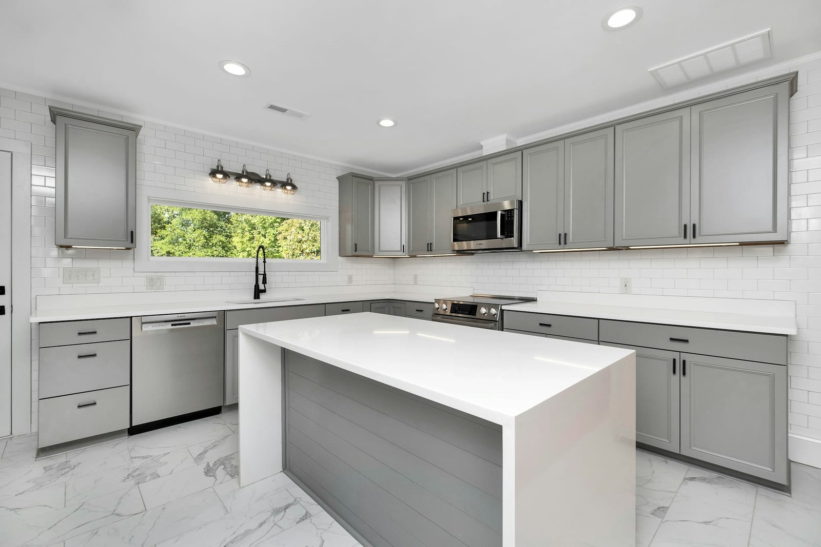 Freshly painted gray kitchen cabinets in a Garland, TX home.