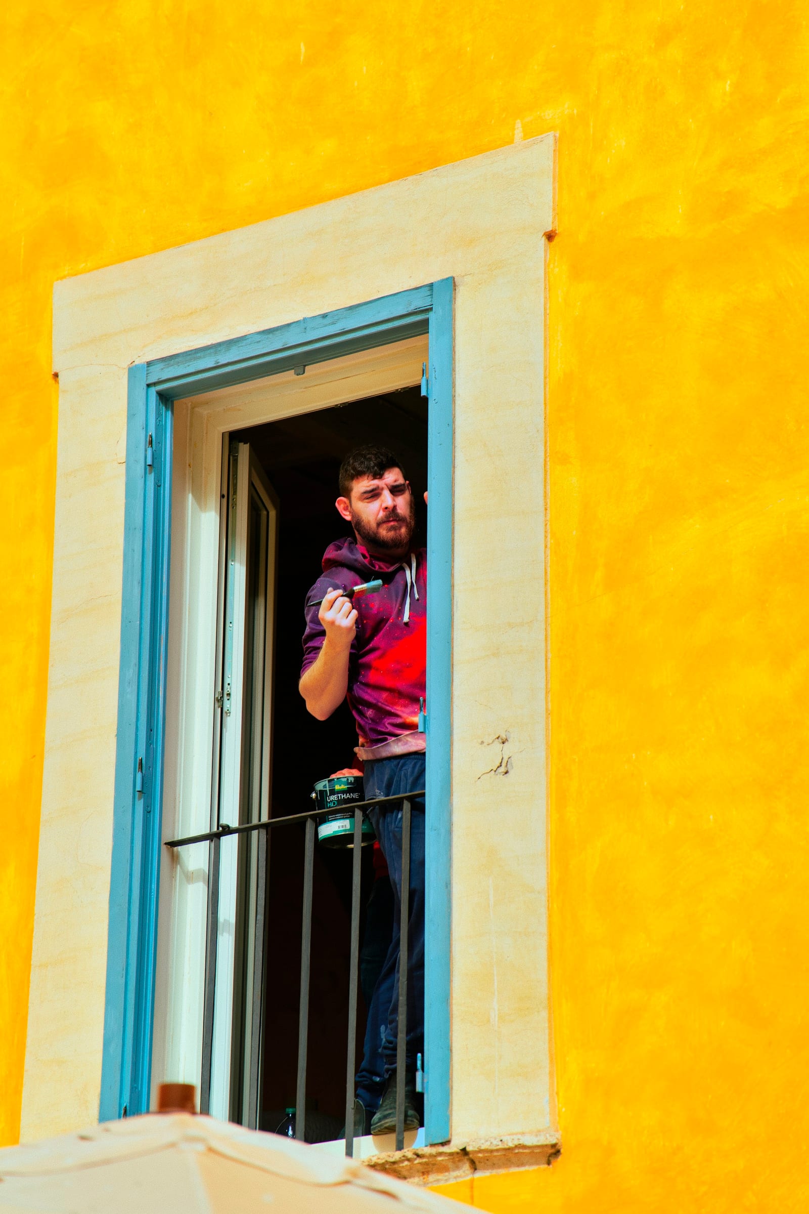 A professional house painter at work on an interior wall in Garland, TX.